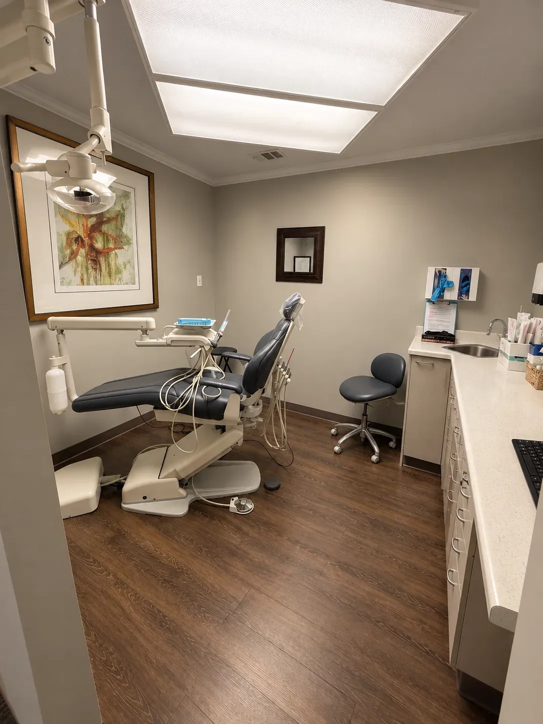 An unoccupied hygiene treatment room with a dental chair at Bencaz Family Dentistry.